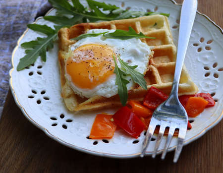 Healthy breakfast . Freshly made, delicious meal of eggs and vegetables. Gluten-free buckwheat waffles with fried eggs Top viewの写真素材