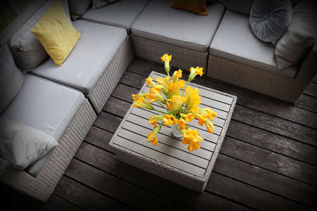Outdoor furniture lounge group with chairs, sofa and table in a patio. Seating on the balcony, is a...