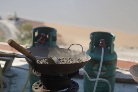 Fresh concrete roasting in steel pan for water content checkingの写真素材