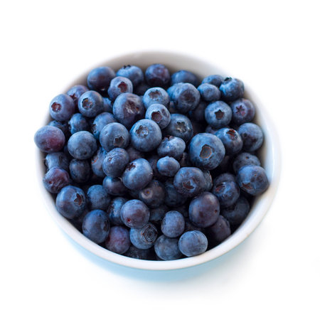 Fresh blueberries in white blue bowl on white background