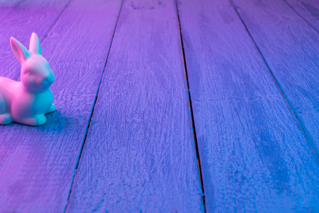 Pink Easter bunny on a blue wooden backgroundの写真素材