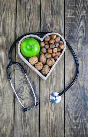 Healthy food in heart and cholesterol diet concept on wooden backgroundの写真素材