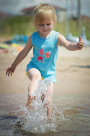 Little girl squirts water in summer funの写真素材