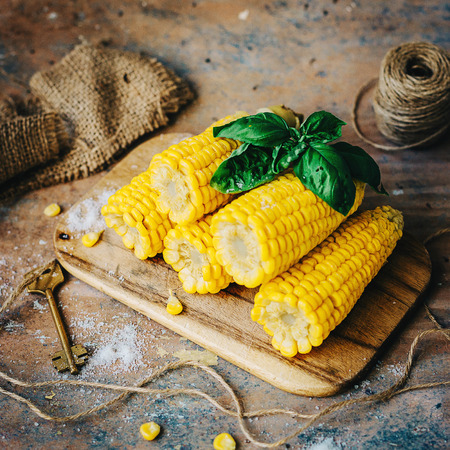 Delicious golden Grilled  Corns  on rustic tableの写真素材