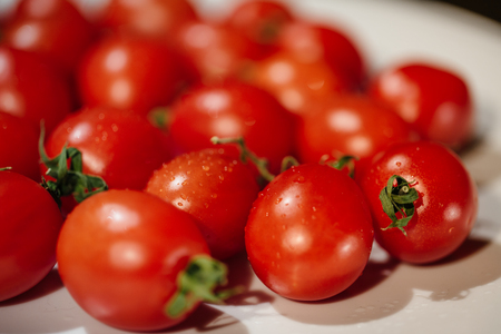 Bunch of red tasty fresh tomatos on the white background.の写真素材