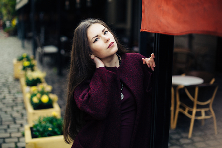 young woman in  coat posingの写真素材