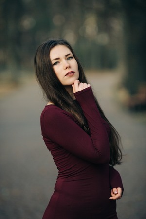 young woman in  coat posingの写真素材