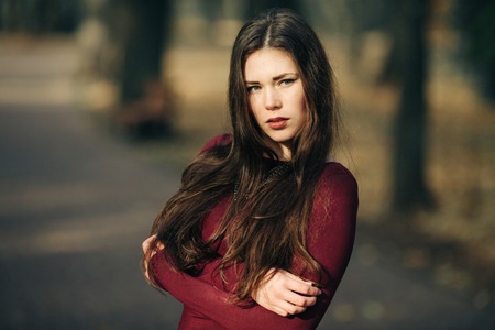 young woman in  coat posingの写真素材