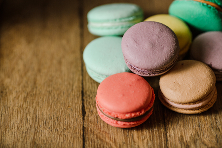 vivid color macaroons on wooden tableの写真素材