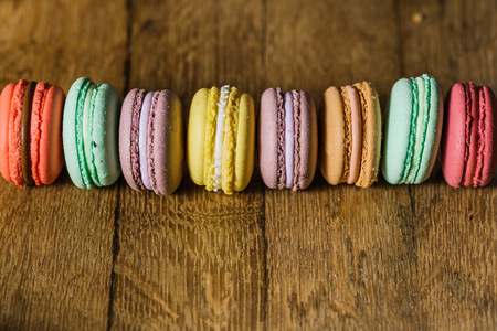 Cake macaron or macaroon on turquoise background from above, colの写真素材