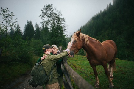 Romantic young couple in love, a walk on a horse on nature backgの写真素材