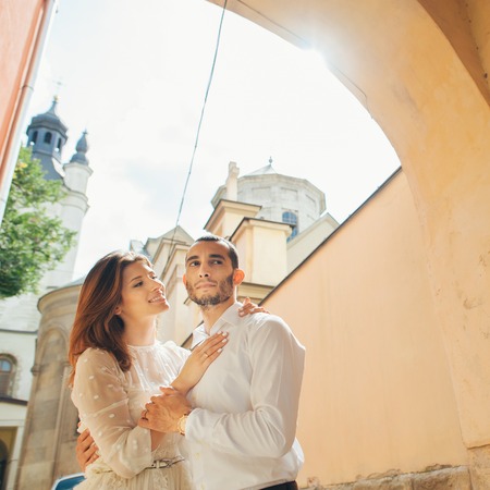 portrait of beautiful bride hugging her handsome groom outdoorsの写真素材