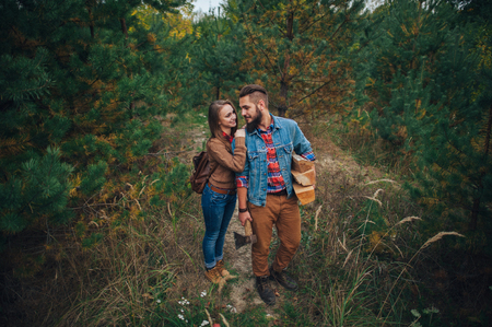 Beautiful young couple in a pine forestの写真素材