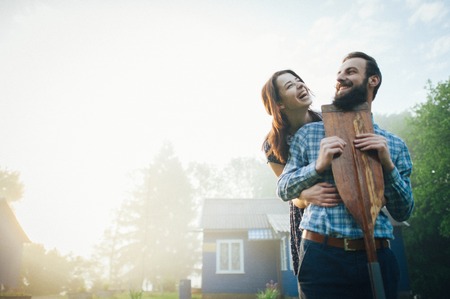 man and woman standing  on coast of lakeの写真素材
