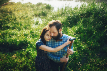 couple in love and reeds on lakeの写真素材