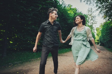 Couple in love laughing looking at each other in the parkの写真素材