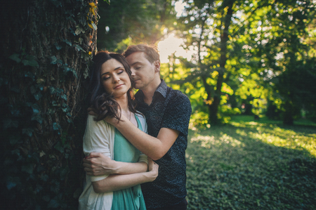 Cute couple kissing in the park on a sunny dayの写真素材