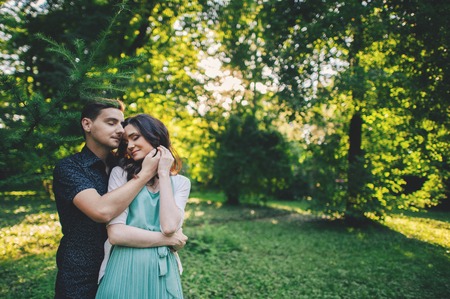 The handsome young man gently hugs and leaning his beautiful girの写真素材