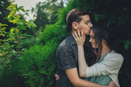 Couple in love laughing looking at each other in the parkの写真素材