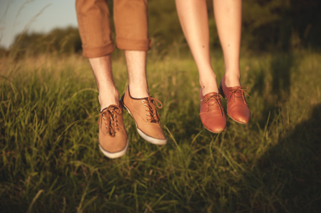 Portrait of happy young couple having fun in a park.の写真素材