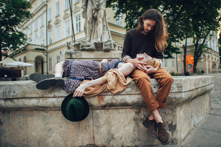 Couple in love are walking around the city in sunny morningの写真素材
