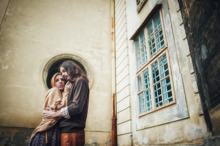Young couple in love, kissing near vintage metal doorの写真素材