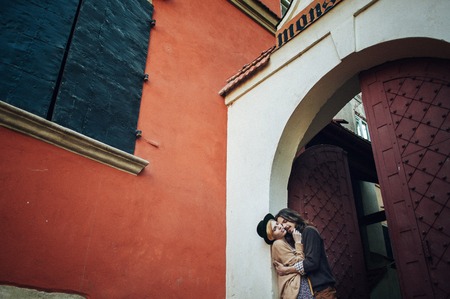 Young couple in love, kissing near vintage metal doorの写真素材