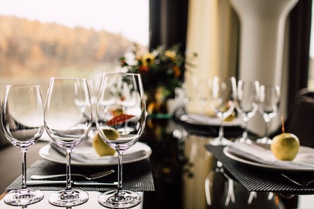 Sparkling glassware stands on long table prepared for wedding diの写真素材