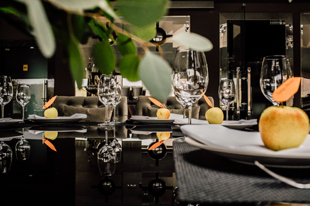 Sparkling glassware stands on long table prepared for wedding diの写真素材