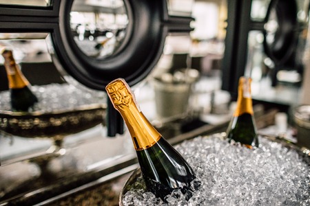 Champagne bottles in a metal bucket on a wedding tableの写真素材