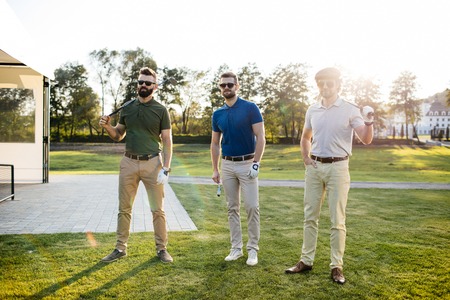 Man playing golf on a golf course in the sunの写真素材
