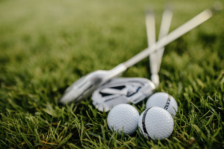 Golf clubs drivers over green field background. Summer sunsetの写真素材