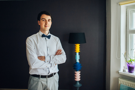 Handsome happy groom before wedding, preparing for weddingの写真素材