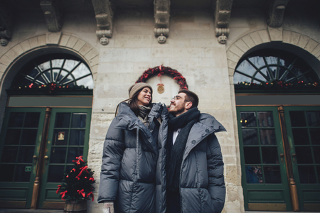Classy groom and his gorgeous bride pose outside in winter coatsの写真素材
