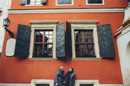 Classy groom and his gorgeous bride pose outside in winter coatsの写真素材