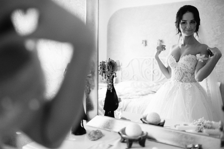 Bridesmaids whirl brides veil while she smilesの写真素材