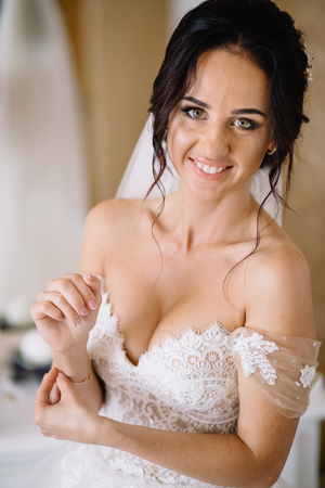 Bridesmaids whirl brides veil while she smilesの写真素材