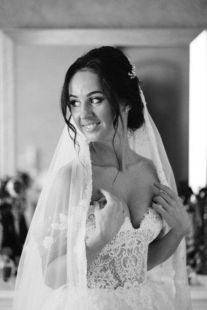 Bridesmaids whirl brides veil while she smilesの写真素材