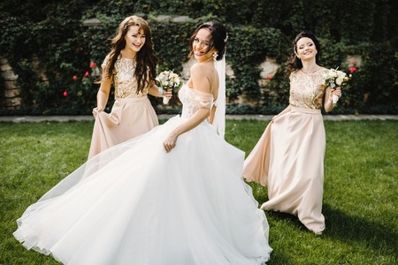 Bride with bridesmaids on the park on the wedding dayの写真素材