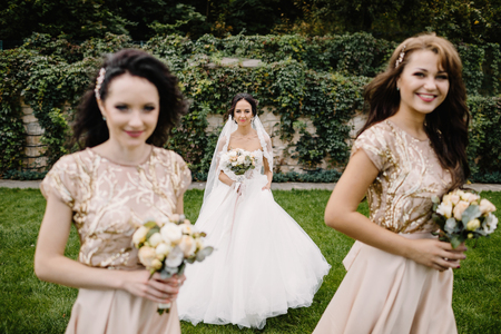 Bride with bridesmaids on the park on the wedding dayの写真素材