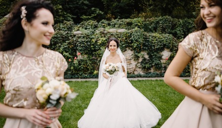 Bride with bridesmaids on the park on the wedding dayの写真素材
