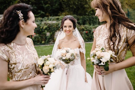 Bride with bridesmaids on the park on the wedding dayの写真素材