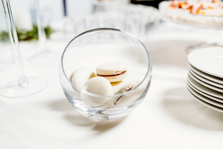 Wedding reception dessert table with delicious decorated white macaroonの写真素材