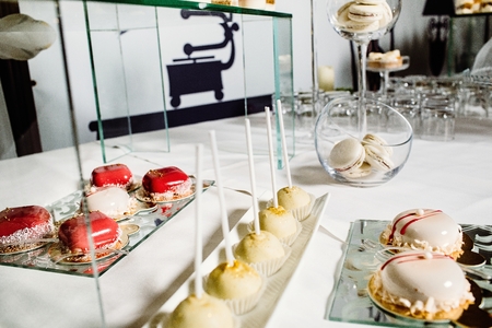 Wedding reception dessert table with delicious decorated white macaroonの写真素材