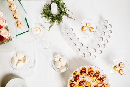 Wedding reception dessert table with delicious decorated white cの写真素材