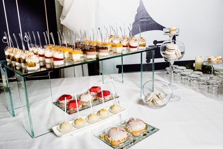 Wedding reception dessert table with delicious decorated white cの写真素材