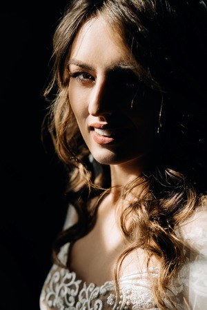 Woman in silk robe with open shoulders looks seductiveの写真素材