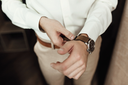 Man checking the time on his wrist watchの写真素材