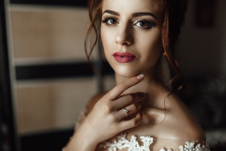 beautiful brunette stylish bride getting ready in the morningの写真素材
