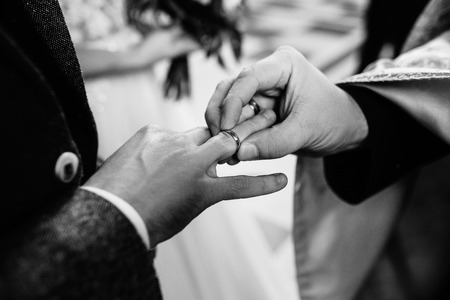 The priest putting the rings for the newlyweds.の写真素材